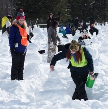 A judge watches someone building their snowman.