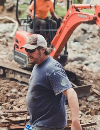 Volunteer carrying a bucket.