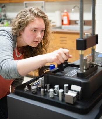 Student calibrating a test machine.