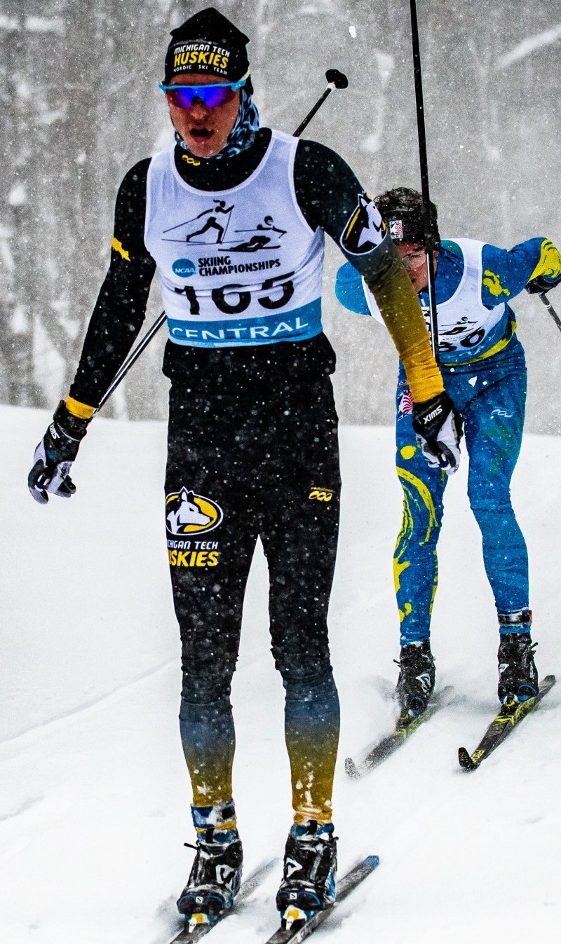 Gaspard Cuenot skiing with a competitor behind him.