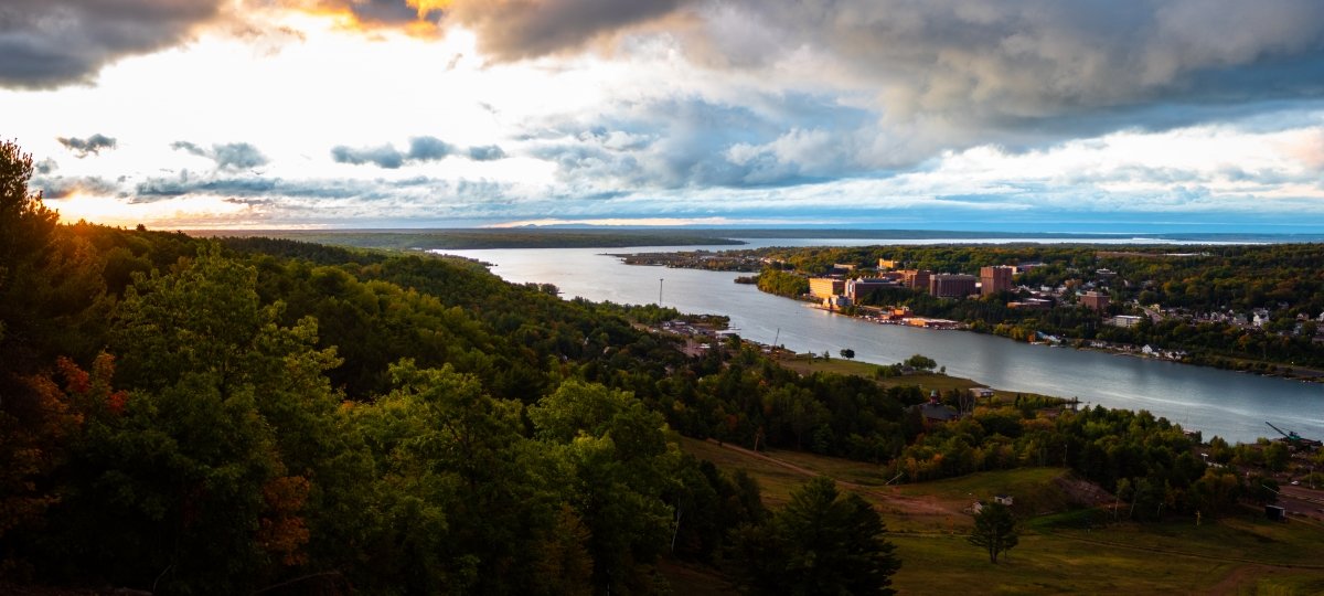 Aerial view of campus and the sun rising.