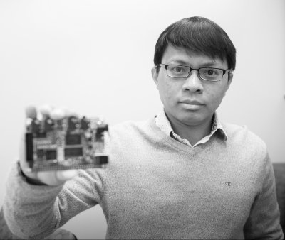 Bo Chen holding a circuit board.