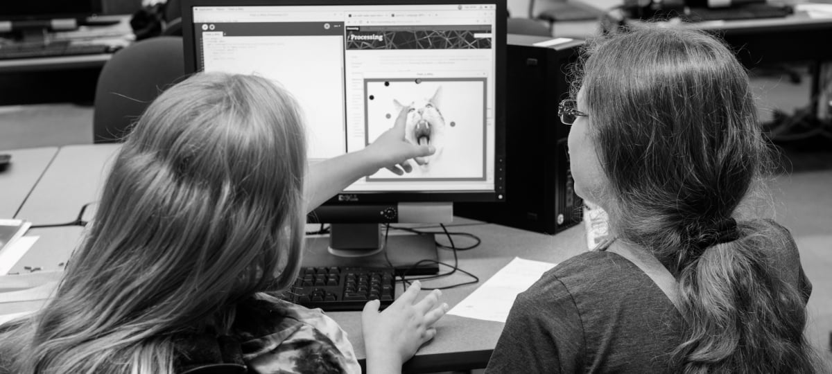 Two students working at a computer.