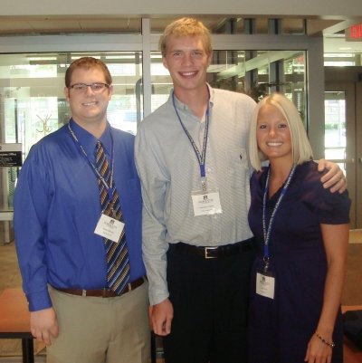 Three people standing together.