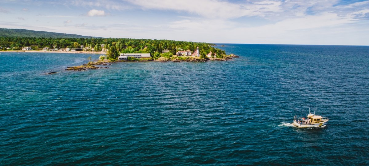 Aerial view of a boat in the water near land.