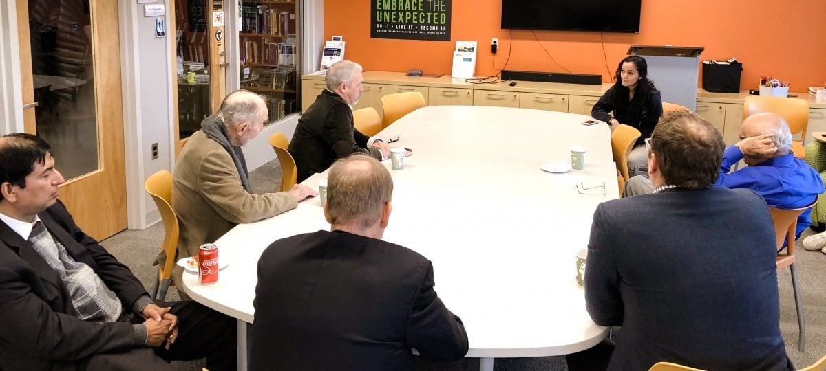 People sitting around a conference table.