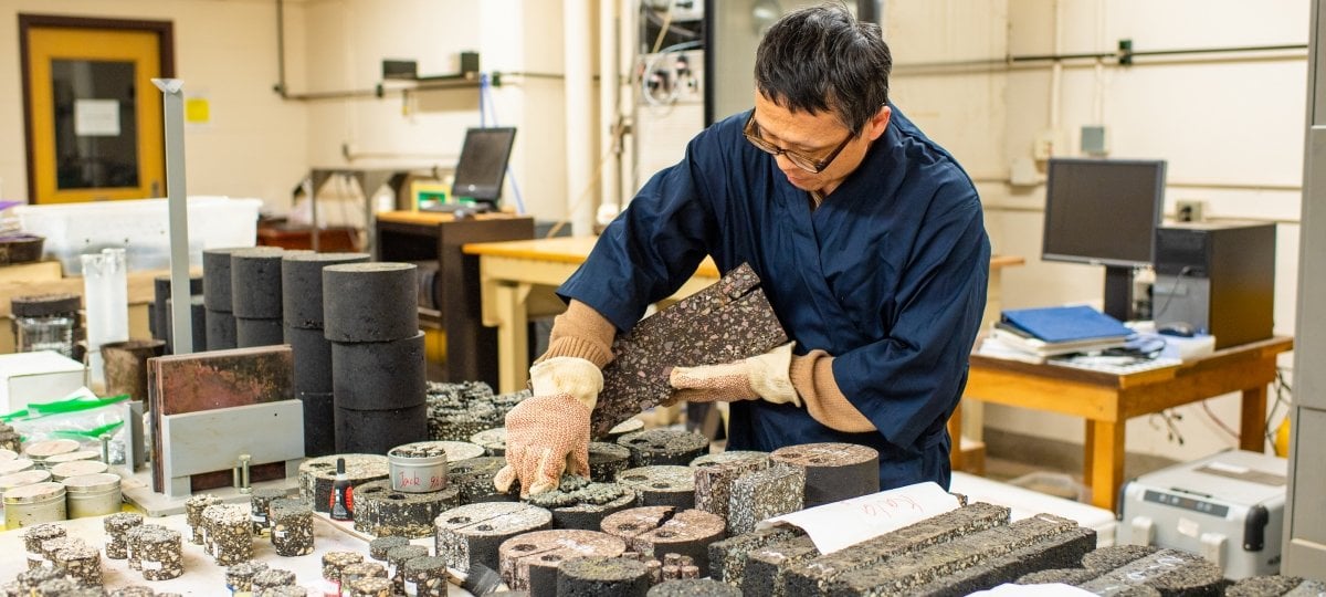 Zhanping You working with surface samples on a lab table.