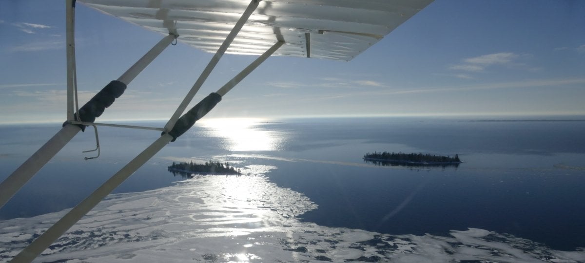 The plane wing and the island in the water below.