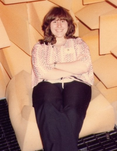 Judy Swann sitting on foam in a room with foam covered walls.