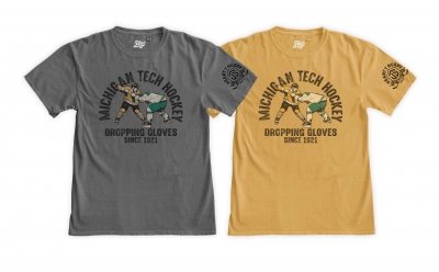 Two tees showing two hockey players fighting with the words MIchigan Tech Hockey, Dropping Gloves Since 1921.