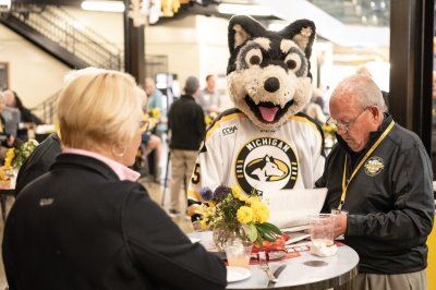 Blizzard visiting alumni at a table at the hockey game.