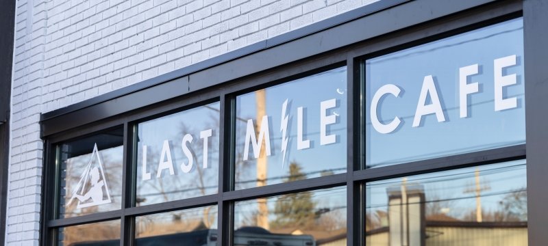Windows with "Last Mile Cafe".