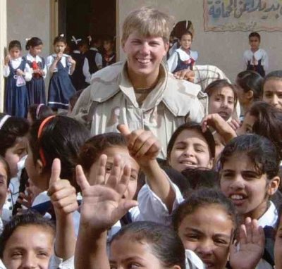 Juliana with children in a schoolyard.