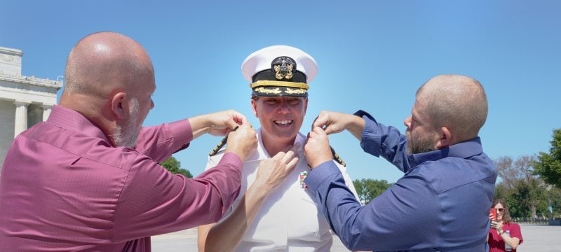 Juliana's brothers helping her get ready for her promotion to captain.