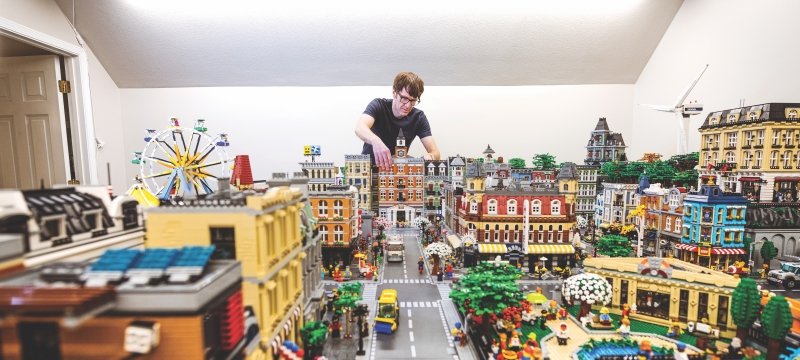 Dennis Livesay adjusting some Legos on his giant city.