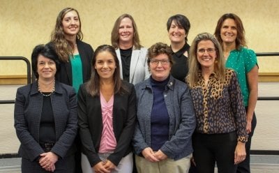 Group of eight women in two rows.