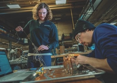 Travis and another student working in the lab.