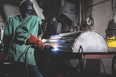 Two students welding.