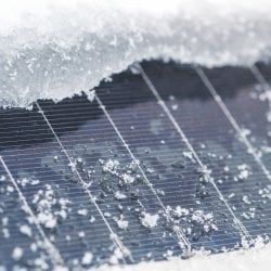 Snow around the edge of a solar panel.
