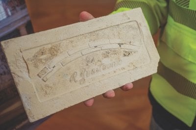 The back of a Guastavino tile stamped with the maker's mark.