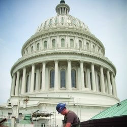 Construction worker in front of the US Capitol Building.