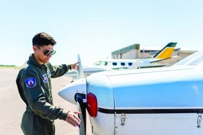 Jonathan Willis inspects an airplane propellar.