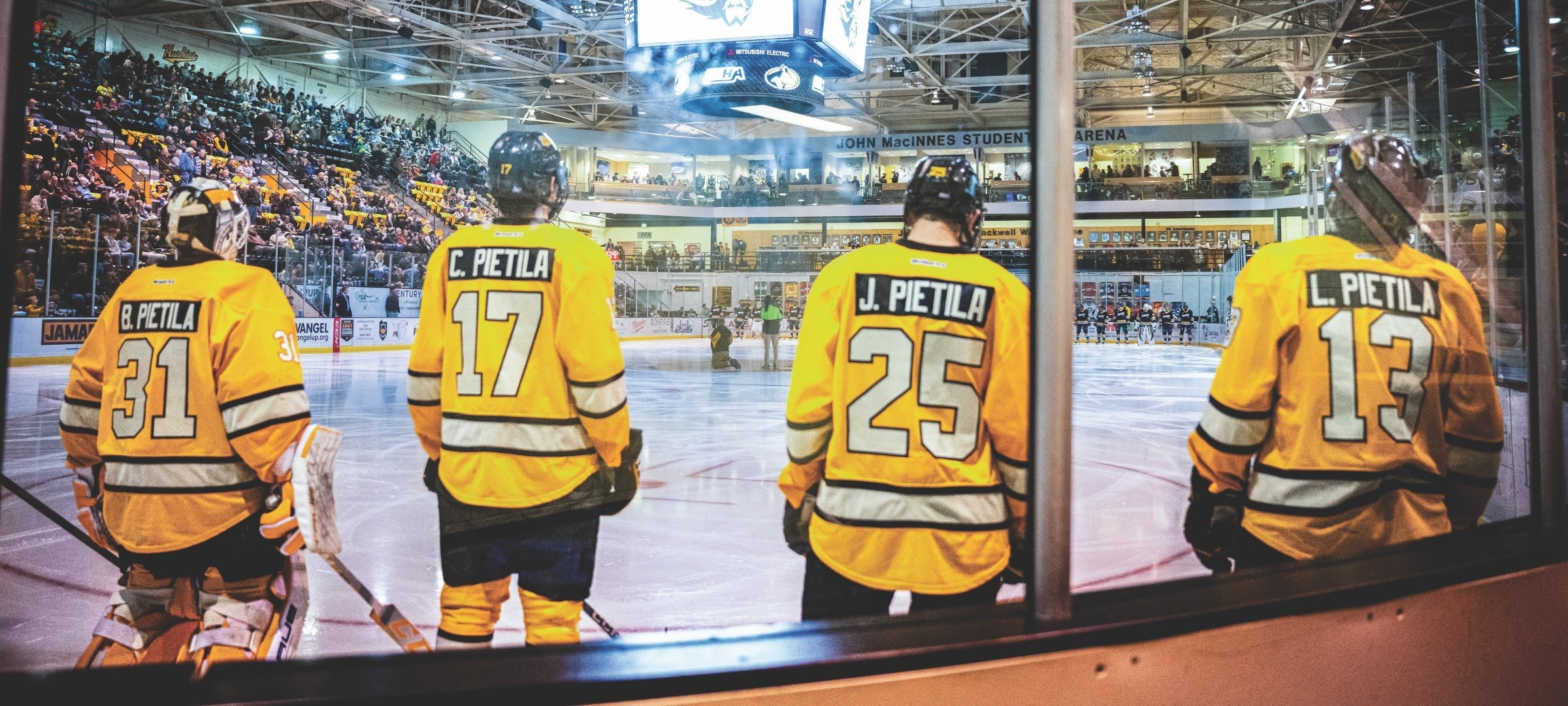 The four Pietila's from the back during lineup before a game.