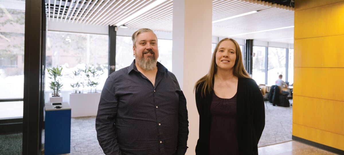 Kevin Trewartha and Carolyn Duncan standing in the H-STEM Complex lobby.