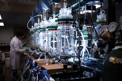 Researcher standing in front of the flotation tanks in the lab.