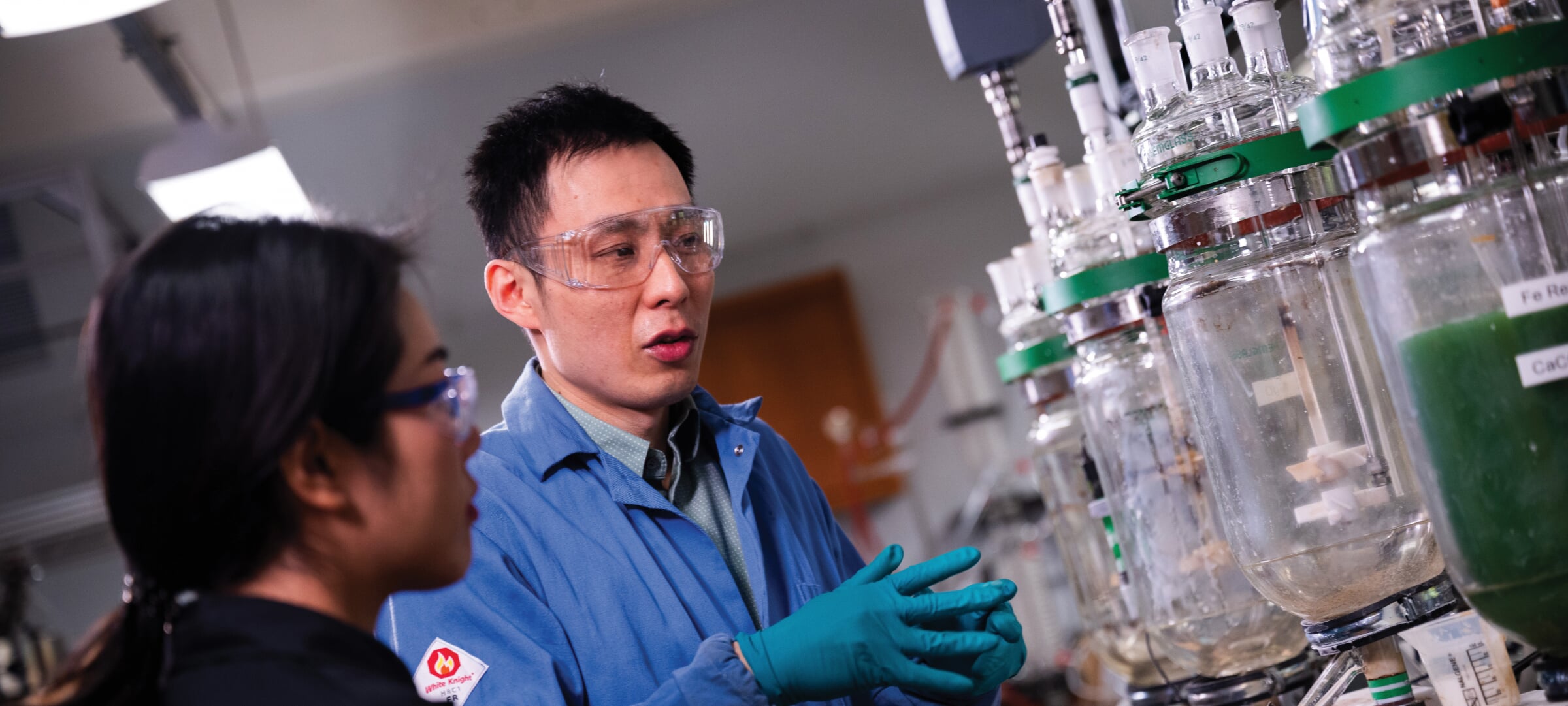 Lei Pan and a student looking at water separation tanks.