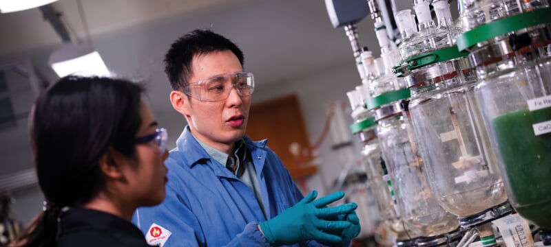 Lei Pan and a student looking at water separation tanks.