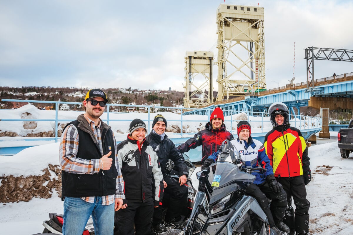 The Sledheads gathered around a few snowmobiles by the Portage Lake Lift Bridge.