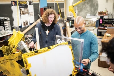 Two students building the rover.