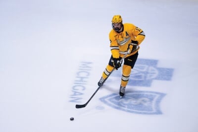 Alternate captain Chase Pietila in uniform on the ice handling a puck.