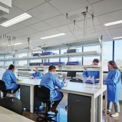 Student working at a table in a lab.