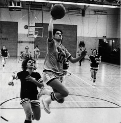 Women playing basketball in the 1970's in black-and-white.