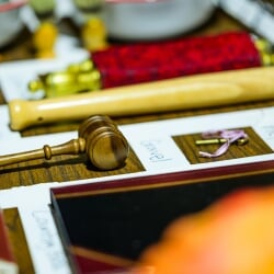 Props, including a gavel and key, laid out on a board and labeled.