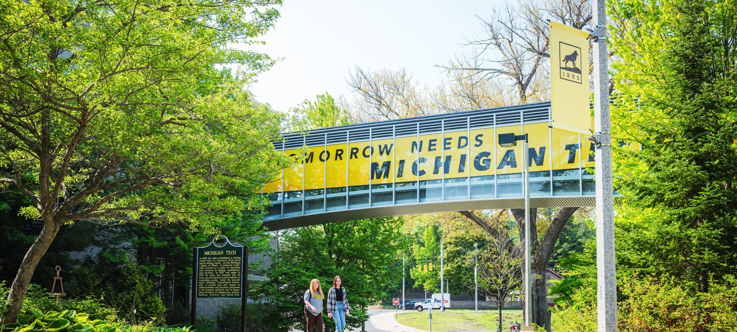Rekhi Hall to Library bridge with Tomorrow Needs Michigan Tech wrap.