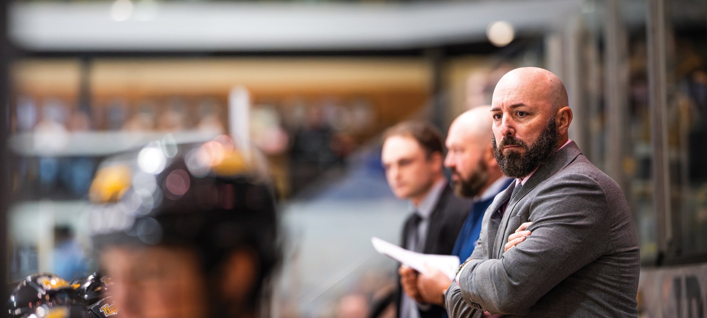 Bill Muckalt on the Huskies bench during a hockey game.