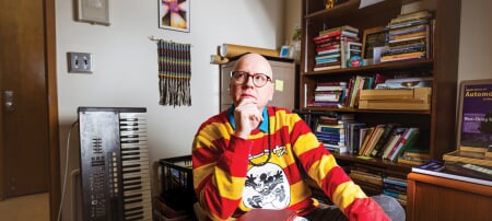 Robert Schneider, in his book-and-curio-stacked Fisher Hall office, found his way to Tech in 2022 in part thanks to a spring break ice storm that trapped him and wife Marci in the Keweenaw after his job interview. â€œWe got to spend three extra days that were forced on us and we fell in love with it. Itâ€™s such a quirky and beautiful little town,â€ he says.