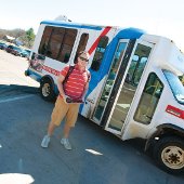 Shawn Wiegand next to a city bus.