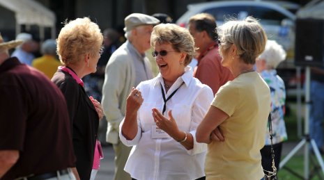 Three people talking during reunion.