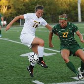 Michigan Tech soccer player keeping the ball from the other team.