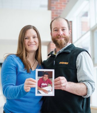 Emily Gochis and Hans Lechner holding a photo of Marvin Rene Huezo Mendoza