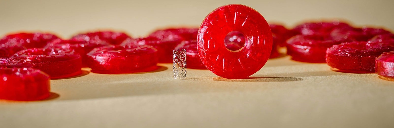 A zinc stent next to a Life Saver candy for a sense of scale.