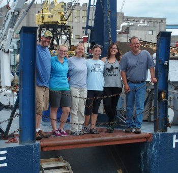 UNOLS Barnard (left) and the University-National Oceanographic Laboratory System (UNOLS) team on the deck of the R/V Blue Heron.