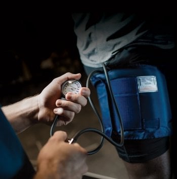 Blood pressure being checked with a cuff.