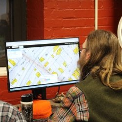 Person looking at a map on a computer monitor.