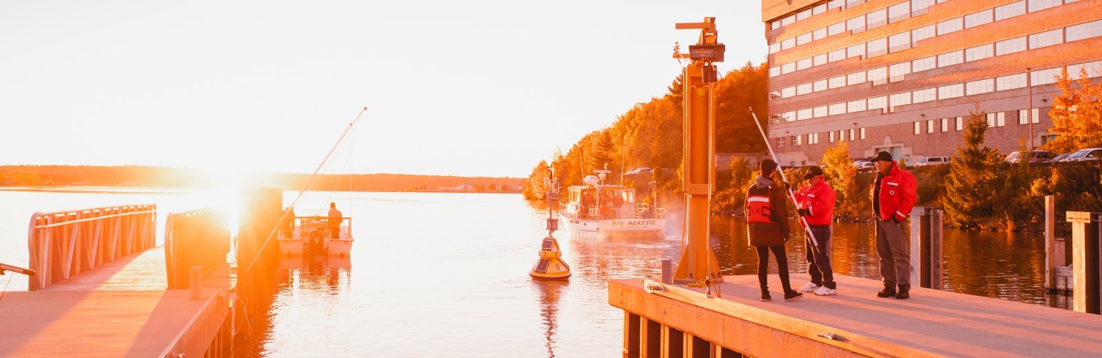 Researchers standing on the dock at the Great Lakes Research Center.