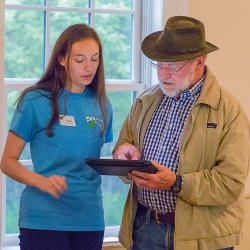 Professor and student looking at a tablet.